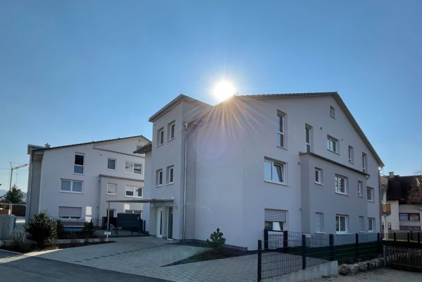 Mehrfamilienhaus mit Satteldach und Gauben – Pfeil Bauträger